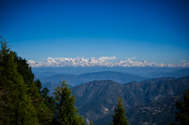 Himalayan snow peaks rising above the clouds