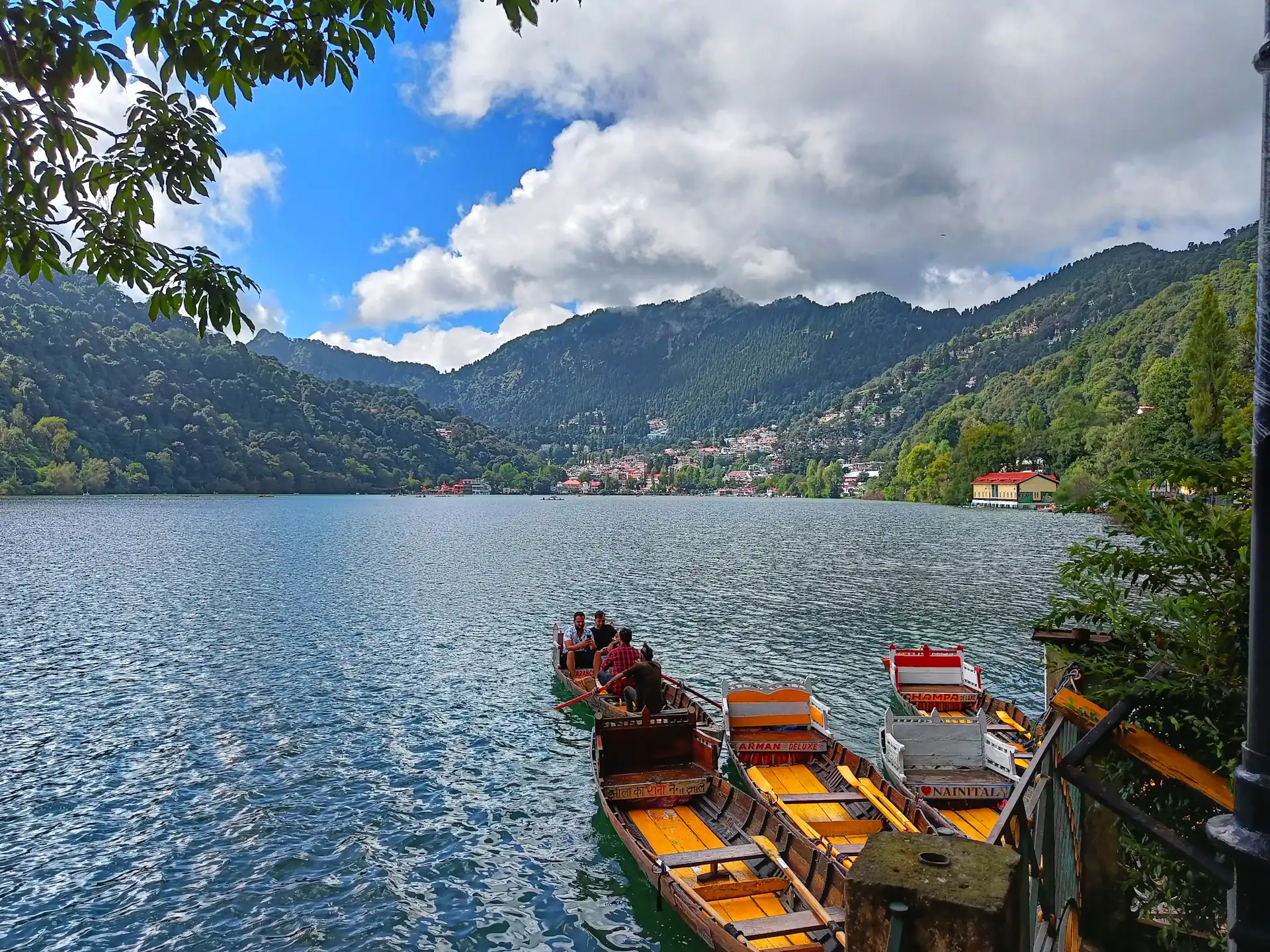 Wooden boats lined up on the shore of Naini Lake