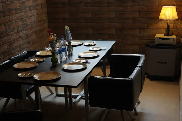 Dining table laid with wooden plates at Nainital Lake View Hotel