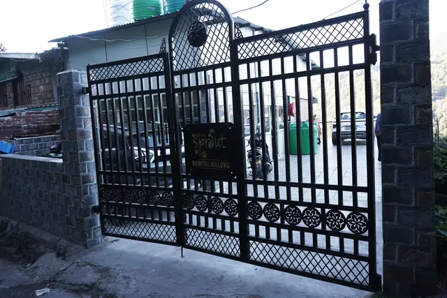 Hotel entrance gate with the Nature's Sprout Nainital Willows sign and parking inside