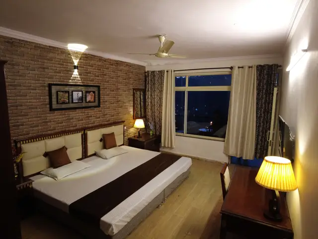 Lake view room with a padded headboard bed facing the balcony window